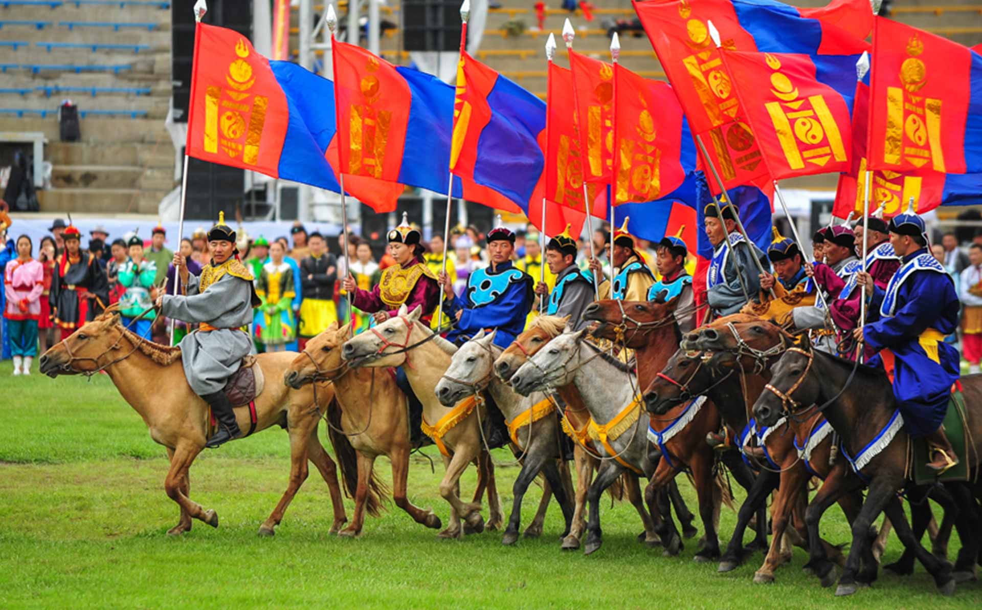 Horsemen bearing the Mongolian flag during the opening ceremony of the Naadam festival.