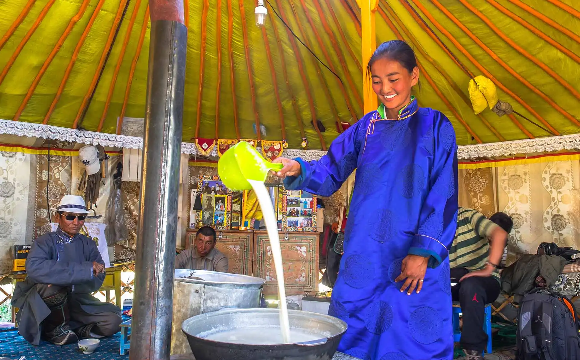 Nomadic woman boils fresh milk to make traditional dairy products.